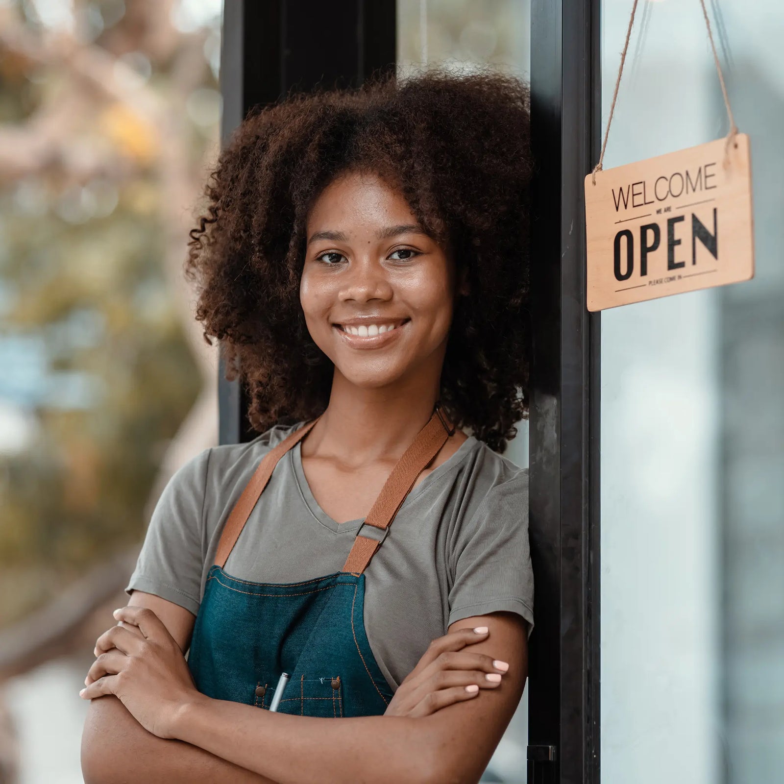 Woman business owner opening up her shop for the day.